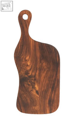 A dark brown tropical rosewood cutting board with organic shape and natural finish featuring an integrated handle
