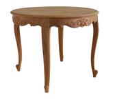 Light brown hand made round capriolet leg dining table with ornate carved legs and decorative floral patterns along edge