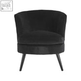 Round plush black cotton velvet armchair with subtle stitching and sleek tapered legs for stylish comfort