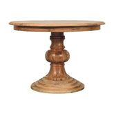 A rustic round turned dining table with a natural wood grain finish and a sturdy pedestal base