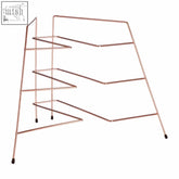 Rowan copper plated metal wire rack with four angled shelves and black feet for copper plated corner plate storage