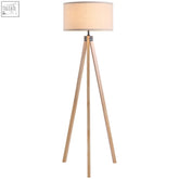 A minimalist rubber wood tripod floor lamp with light wooden legs and a beige fabric shade perfect for cozy lighting