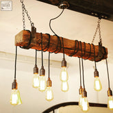 Rustic oak beam chandelier with wrapped cables and steel brackets features exposed edison bulbs and black corded chains great for client area lighting and current lead time updates