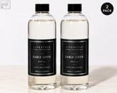 Two clear glass bottles with black caps and minimalist labels each holding 500ml premium xxl sable onyx diffuser refill
