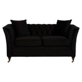 Black velvet tufted sabrina 2-seat onyx sofa with matching cushions and ornate gold-tone legs in a living room