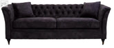 Grey velvet sofa with black velvet tufted design, rolled arms, and dark cushion pillows for cozy seating
