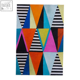 Geometric-patterned area rug with bold orange pink teal and black and white stripes for genuine leather multicolour wall art