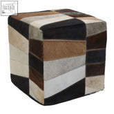 A safira hair on leather pouffe cube ottoman with geometric patchwork design in black brown beige and white panels