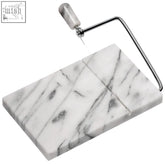 White marble cheese slicer with sleek metallic wire and handle on salerno white marble cheese board