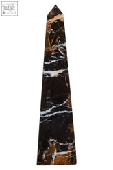A sleek salmo large black marble obelisk with striking white and gold veining for elegant decor