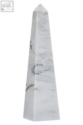 A sleek salmo large white marble obelisk with elegant gray veining and a polished smooth finish