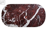 A sleek salmo oval red serving board made of burgundy oval red marble with striking white veining