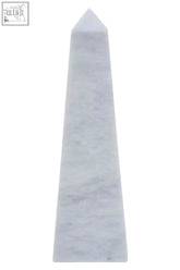 A sleek salmo small white marble obelisk with smooth polished surface and subtle gray veining