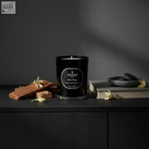 Black magic black glass candle with silver label and white wax sandalwood and ylang ylang scent with coreless clean-burn technology
