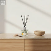 Clear glass santal vanille diffuser with black reeds and silver cap offering creamy fragrance for living rooms