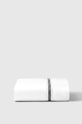 White sateen fitted sheet with subtle black textured stripe down center made of soft cotton