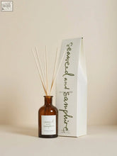 A sleek amber glass seaweed and samphire diffuser with white reeds and zesty citrus 100ml fragrance in vegetable oil base