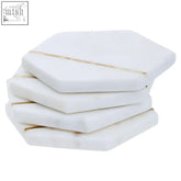 Sena set of four white marble coasters with white hexagonal shape and subtle gold veining for stylish drink protection