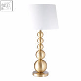 Senna stacked table lamp with a gold-toned tiered sphere base and white cylindrical shade perfect for any room