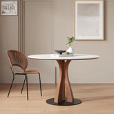 Seraphim round dining table with white marble top and sculptural walnut wood base on black circular pedestal