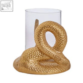Gold candle holder shaped like a textured serpent with a clear glass cylinder for holding a candle