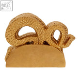 Gold-colored textured metal serpent gold set featuring two intertwined snakes coiled above a taco-shaped base coaster holder