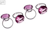 Set of four purple diamante napkin rings with pink sparkling gemstones and sleek silver bands resembling engagement rings