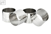 Set of four hammered silver finish napkin rings with a textured reflective surface for elegant table settings