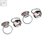 Set of five chrome napkin rings with faceted pink gemstone centerpiece, not matching the four smoke grey diamante set