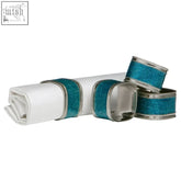 Set of four turquoise glitter napkin rings with teal glitter and silver trim for stylish table settings