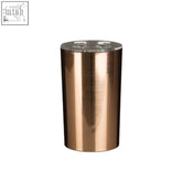 Shine toothbrush holder in rose gold finish with a copper-colored cylindrical metallic tumbler and clear lid cutouts