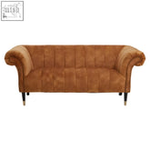 Tan suede chesterfield sofa with rolled arms and nailhead trim seen with siena two seat gold velvet sofa style