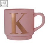 A matte pink ceramic monogram mug with a large metallic gold letter k perfect as a pink k monogram mug