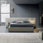 Modern gray simupo bed with textured fabric upholstery and sleek minimalist design featuring hidden storage options