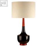 Sirus table lamp with black glossy ceramic base, cream linen shade, and reddish-brown wooden accents for cozy lighting