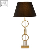 Skye gold finish table lamp with gold-toned stacked circular ring base and black textured shade for stylish lighting
