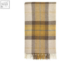 A cozy cream and mustard yellow plaid wool throw blanket with soft fringe called skye shetland pure new wool throw gold