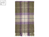 A soft skye shetland pure new wool throw in olive and lavender plaid with a textured weave and fringed edges