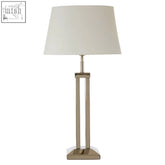 A sleek skye table lamp with a brushed metallic dual rod base and a soft off-white fabric shade