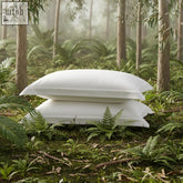Two white eucalyptus silk pillow protectors neatly stacked on a mossy forest floor from sleepyhead pillow set