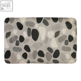 Soak grey pebble bath mat is a grey and black pebble patterned bath mat that absorbs water quickly