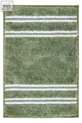 Sage green plush bath mat with three white woven stripes perfect for a cozy green bath mat setup