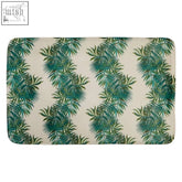 Beige soak winter palm leaf mat with green tropical palm leaf pattern perfect for bath use