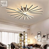 Modern starburst ceiling light with sleek black and white led bars radiating from a central circular base solaris light