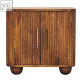 A rustic oak solis fluted mini sideboard chest with vertical grain doors and slender brass handles in solid mango wood
