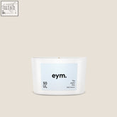 A minimalist white mini candle in a sleek glass container with a light blue eym label called soul mini candle