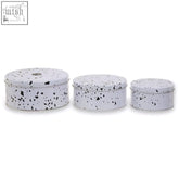 Set of three white enamel cake storage tins with black speckled pattern perfect for cake storage and organization