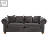 Dark gray velvet chesterfield fabric sofa with rolled arms and wooden legs perfect as a grey fabric sofa centerpiece
