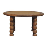 Round wooden coffee table with woven cane top and turned ball legs perfect for stylish living spaces