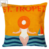 Vibrant orange tropez needlepoint cushion with embroidered figure in wide-brimmed hat and seaside st backdrop
